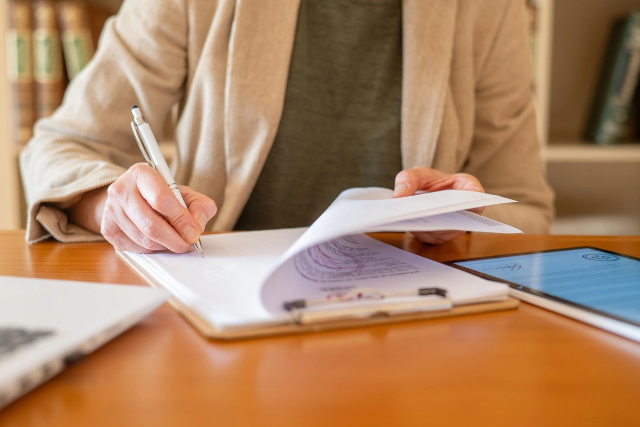 Financial Planning for Business Owners Stoic Wealth Advisors Business owner reviewing and signing financial planning documents during a strategic consultation