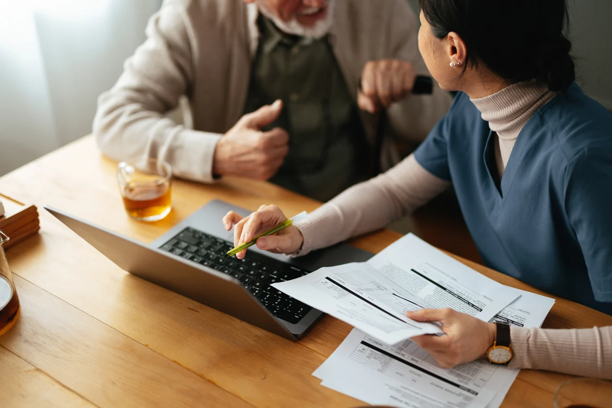 Trusted Retirement Planning Guidance | Stoic Wealth Advisors Advisor reviewing retirement and financial documents with a senior client during a personalized meeting